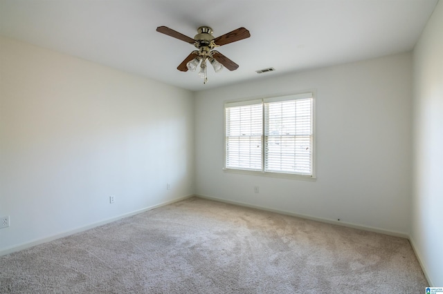 carpeted spare room featuring ceiling fan