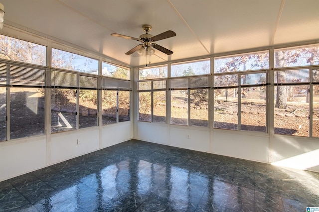 unfurnished sunroom with ceiling fan