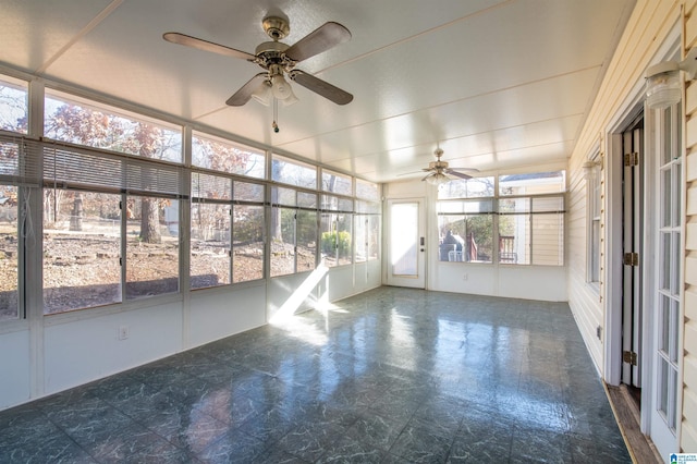 unfurnished sunroom with ceiling fan