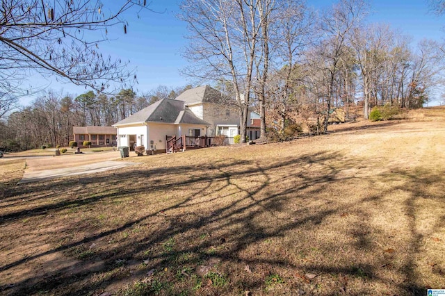 view of property exterior featuring a lawn and a deck