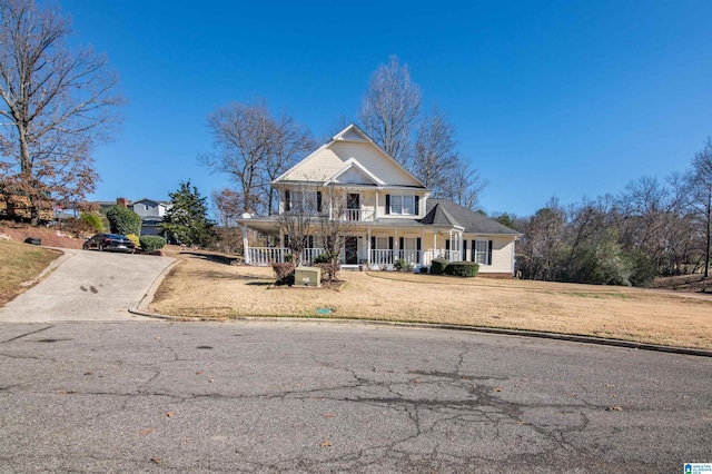 view of front of property with covered porch and a front yard