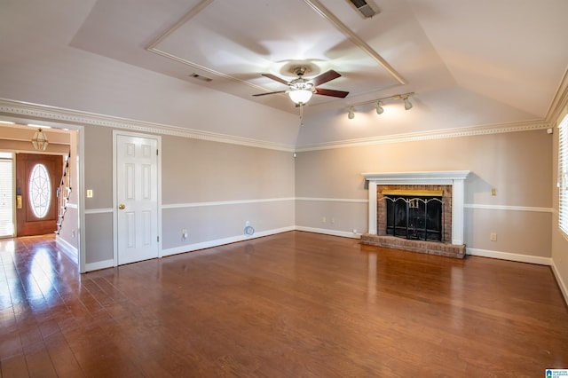 unfurnished living room featuring lofted ceiling, a brick fireplace, ceiling fan, and dark wood-type flooring