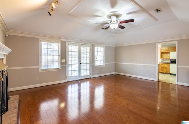 unfurnished living room featuring dark wood-type flooring, french doors, a brick fireplace, ceiling fan, and ornamental molding