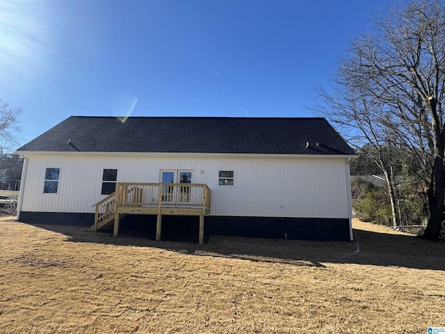 rear view of property featuring a deck