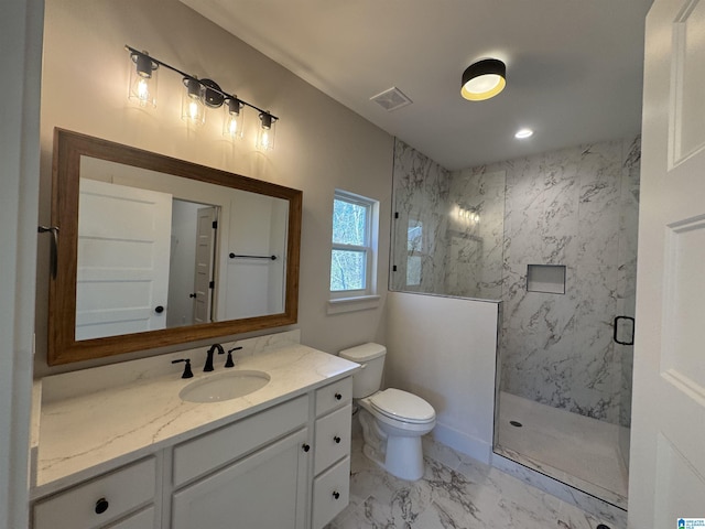 bathroom with toilet, vanity, and walk in shower