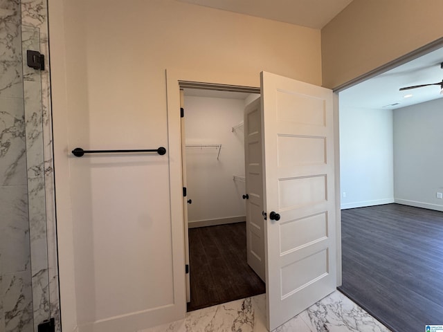 bathroom with ceiling fan, wood-type flooring, and walk in shower