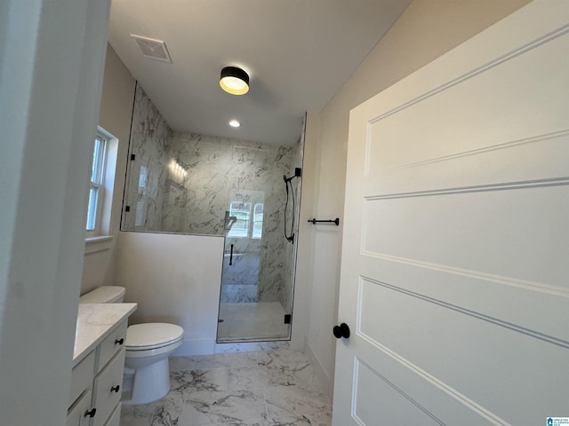 bathroom featuring vanity, toilet, and a shower with shower door