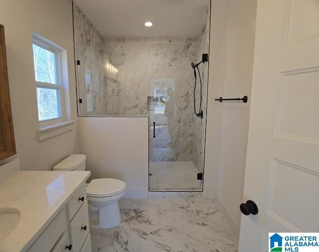 bathroom with vanity, a shower with shower door, and toilet