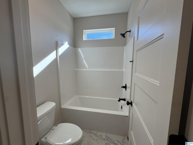 bathroom featuring shower / bathtub combination and toilet