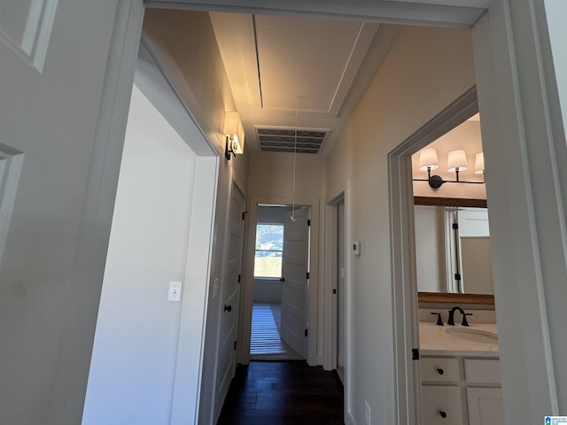 hall featuring dark wood-type flooring and sink