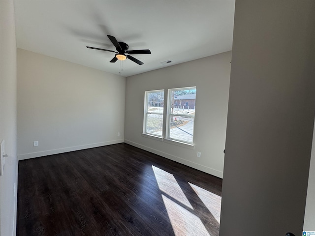 unfurnished room featuring ceiling fan and dark wood-type flooring