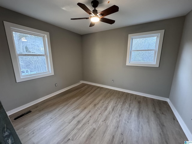 empty room featuring ceiling fan and light hardwood / wood-style flooring