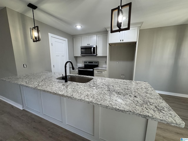 kitchen featuring black electric range, sink, hanging light fixtures, light stone countertops, and white cabinets