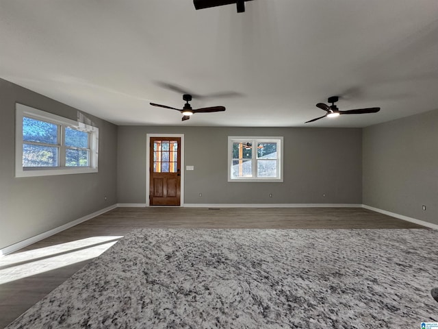 interior space with ceiling fan and wood-type flooring