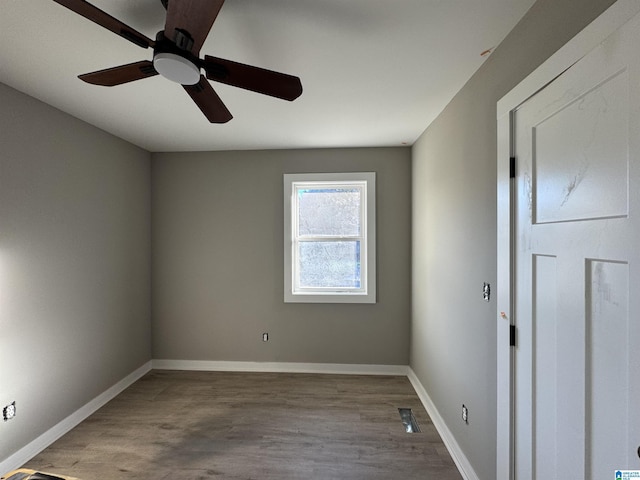 empty room featuring ceiling fan and hardwood / wood-style flooring