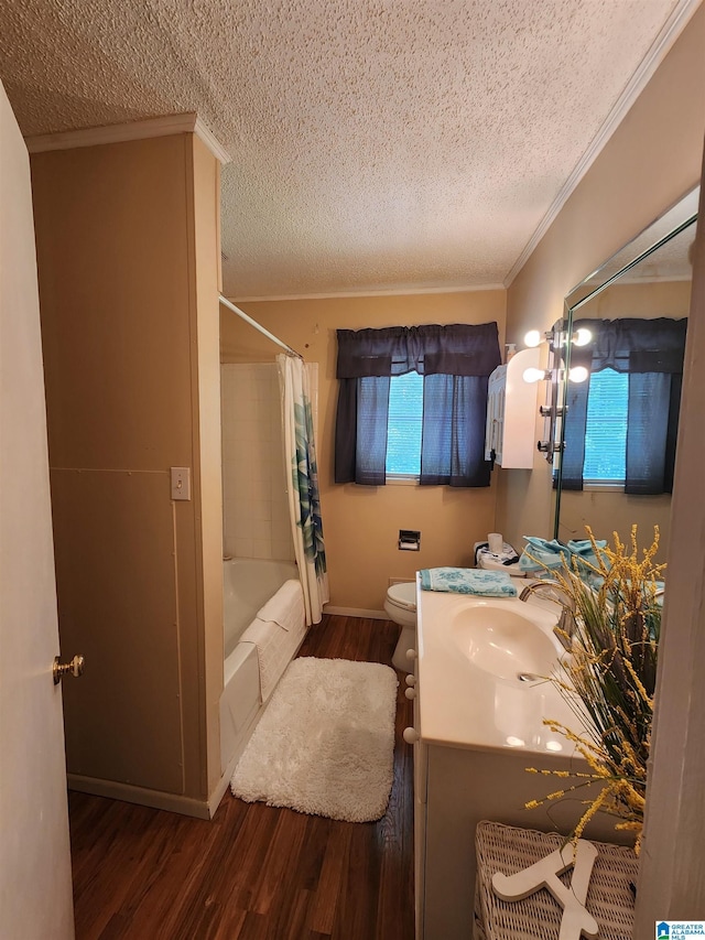 full bathroom featuring a textured ceiling, wood-type flooring, vanity, ornamental molding, and shower / tub combo with curtain