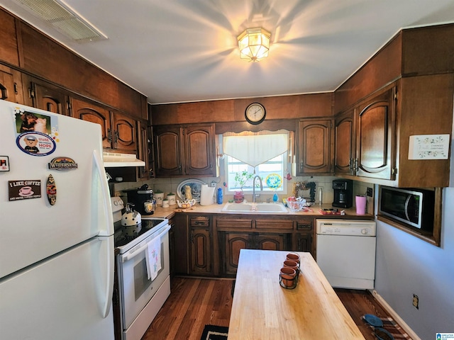 kitchen with decorative backsplash, sink, dark hardwood / wood-style floors, and white appliances