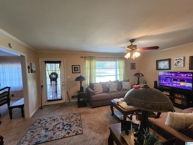 living room with ceiling fan, ornamental molding, and carpet floors