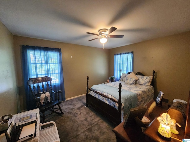 bedroom featuring ceiling fan, multiple windows, and carpet