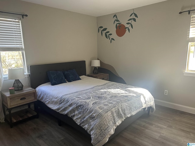 bedroom with hardwood / wood-style floors and multiple windows