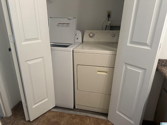 laundry area with washer and clothes dryer and tile patterned floors