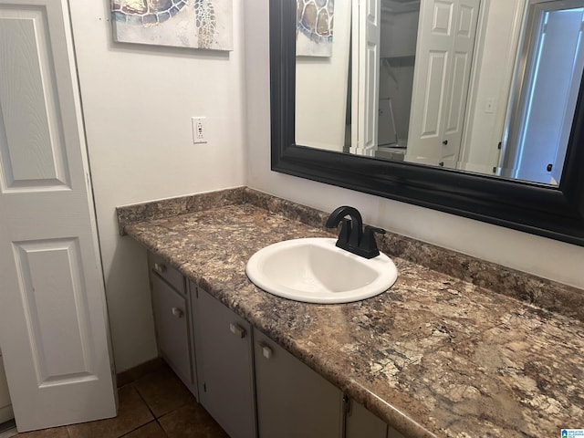 bathroom featuring tile patterned flooring and vanity