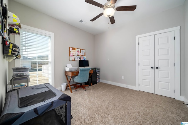 office space with carpet and ceiling fan