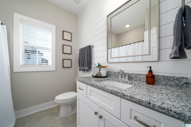 bathroom with tile patterned floors, vanity, and toilet