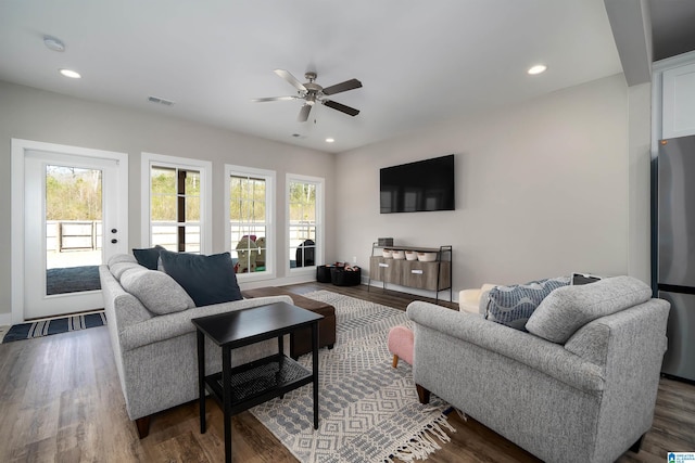 living room featuring dark hardwood / wood-style flooring and ceiling fan