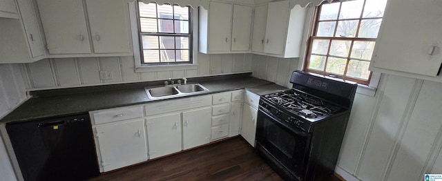 kitchen featuring sink, dark hardwood / wood-style floors, white cabinetry, and black appliances