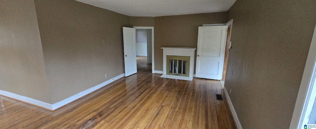 unfurnished living room with hardwood / wood-style flooring