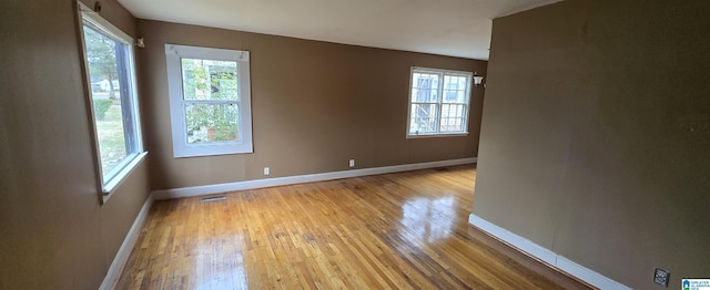 empty room with light hardwood / wood-style flooring