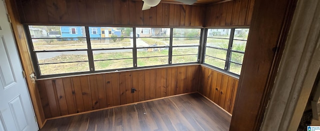 unfurnished sunroom featuring ceiling fan