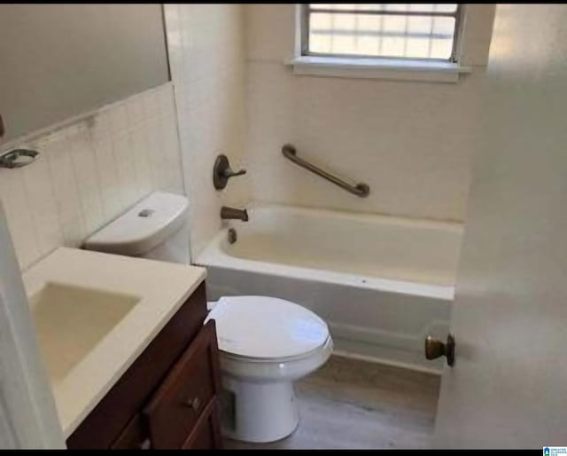 full bathroom featuring vanity,  shower combination, and toilet