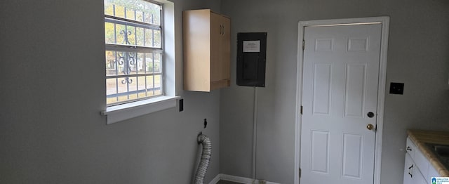 laundry area featuring cabinets, electric panel, and hookup for an electric dryer