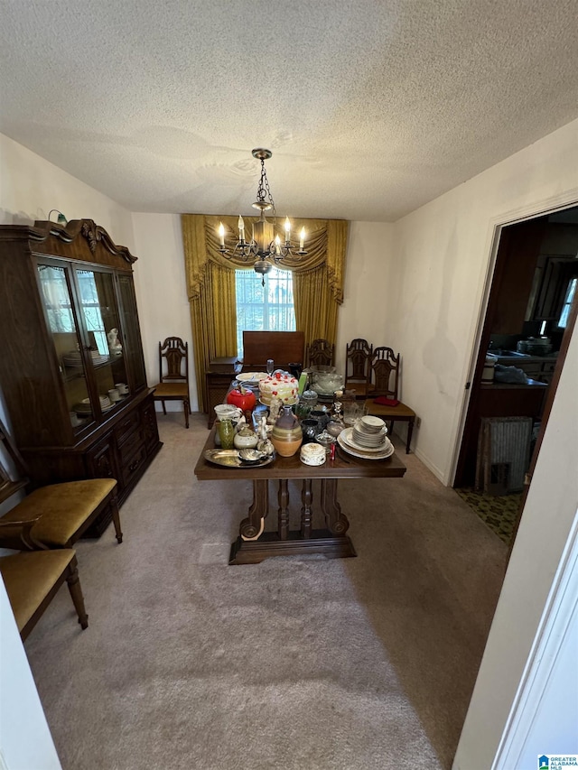 carpeted dining space with a notable chandelier and a textured ceiling