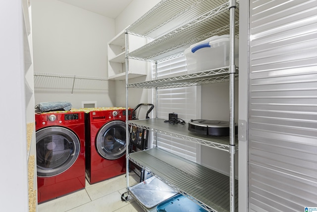 laundry room featuring washing machine and clothes dryer, laundry area, and tile patterned floors