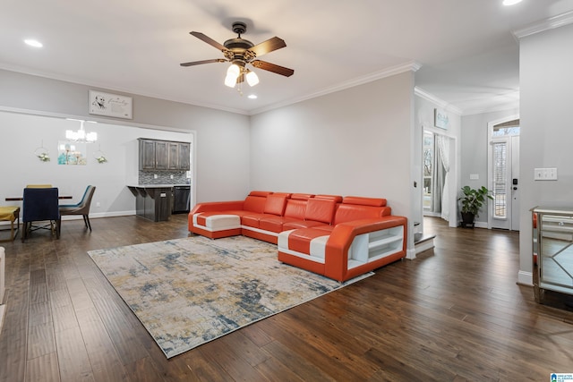 living room featuring baseboards, dark wood finished floors, recessed lighting, crown molding, and ceiling fan with notable chandelier