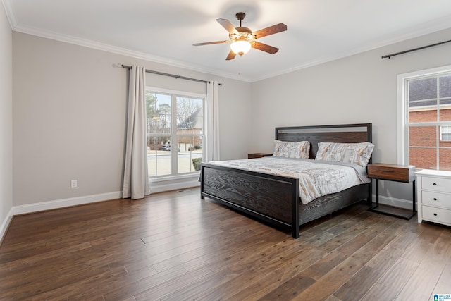 bedroom featuring ceiling fan, baseboards, wood finished floors, and crown molding