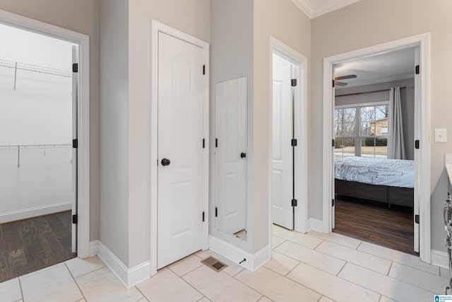 full bath featuring tile patterned floors, ensuite bath, crown molding, and baseboards