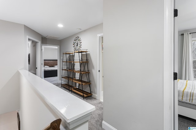 hallway featuring recessed lighting, visible vents, baseboards, and carpet