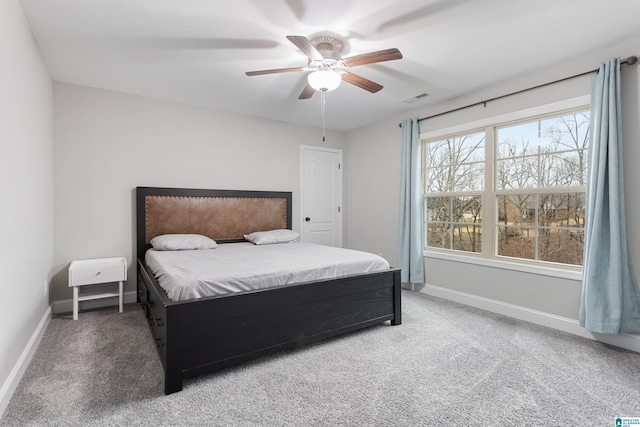 carpeted bedroom with baseboards, visible vents, and ceiling fan