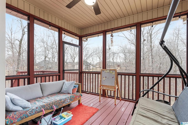 sunroom / solarium with wooden ceiling and a ceiling fan