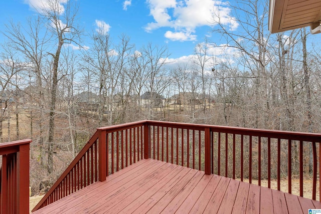 wooden deck featuring a forest view