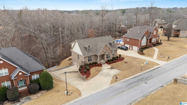 drone / aerial view featuring a wooded view