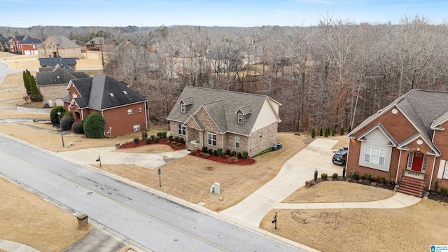 drone / aerial view with a forest view and a residential view