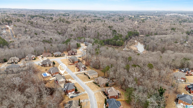 drone / aerial view with a residential view and a wooded view