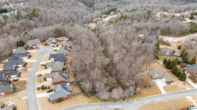 drone / aerial view featuring a residential view and a view of trees