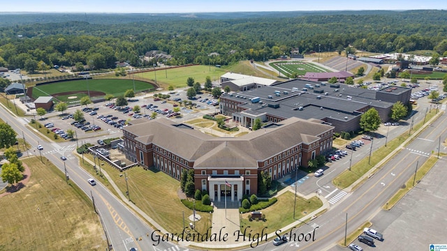 drone / aerial view featuring a wooded view