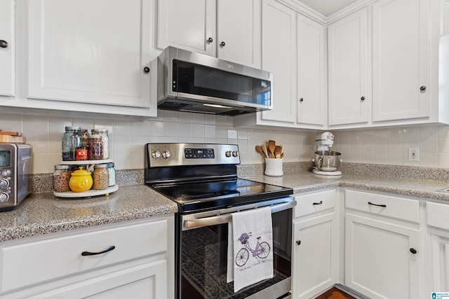 kitchen featuring white cabinetry, backsplash, and appliances with stainless steel finishes